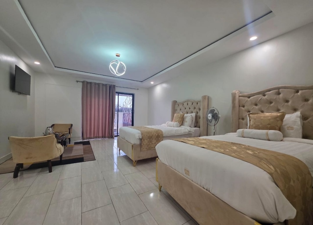 Greys Inn guest room with two beds and gold accents